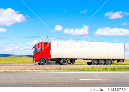 traveling truck with a red cab on a summer day on traveling truck with a red cab on a summer day on 64816770