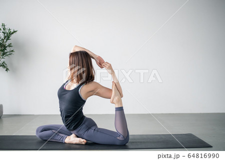 Woman practicing yoga in studio. 64816990