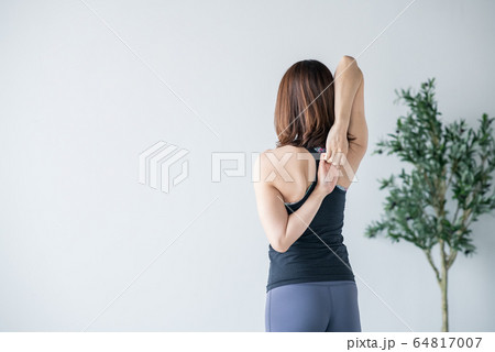 Woman practicing yoga in studio. Woman practicing yoga in studio. 64817007