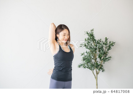 Woman practicing yoga in studio. 64817008