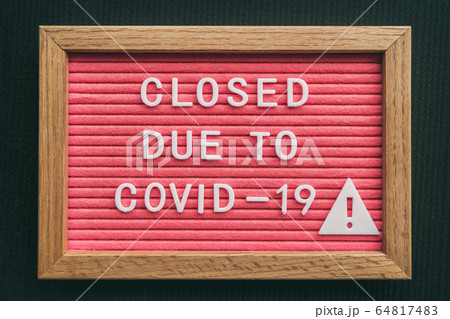 Coronavirus store closure sign. Closed due to COVID-19 message board for retail business COVID-19 pandemic outbreak. Government shutdown of restaurants, bakeries, non essential services. Pink letters Coronavirus store closure sign. Closed due to COVID-19 message board for retail business COVID-19 pandemic outbreak. Government shutdown of restaurants, bakeries, non essential services. Pink letters 64817483