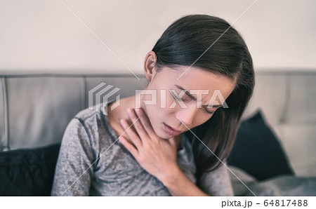 COVID-19 Corona virus symptoms are pneumonia, shortness of breath, chest pain, body aches or breathing difficulties. Asian woman sick of Coronavirus at home COVID-19 Corona virus symptoms are pneumonia, shortness of breath, chest pain, body aches or breathing difficulties. Asian woman sick of Coronavirus at home 64817488