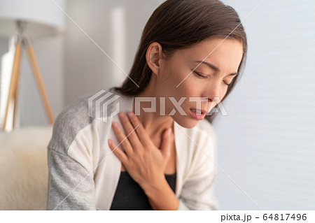 COVID-19 breathing difficulties woman with shortness of breath Coronavirus cough breathing problem. Asian girl in pain touching chest respiratory symptoms fever, coughing, body aches COVID-19 breathing difficulties woman with shortness of breath Coronavirus cough breathing problem. Asian girl in pain touching chest respiratory symptoms fever, coughing, body aches 64817496