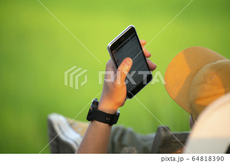 A modern asia man scolling mobile phone monitor A modern asia man scolling mobile phone monitor 64818390