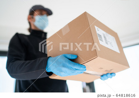 Home delivery shopping box man wearing gloves and protective mask delivering packages at door Home delivery shopping box man wearing gloves and protective mask delivering packages at door 64818616