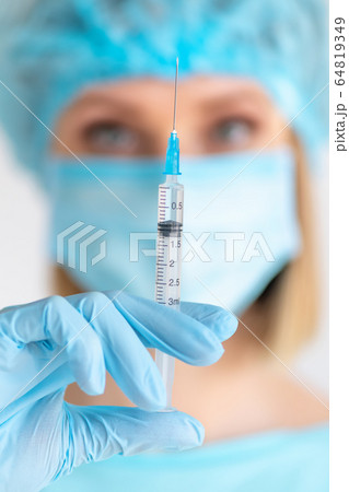 Syringe for injection in nurse hand. Medical glass Syringe for injection in nurse hand. Medical glass 64819349