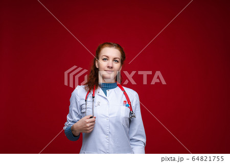 Beautiful red-haired doctor in lab coat with Beautiful red-haired doctor in lab coat with 64821755