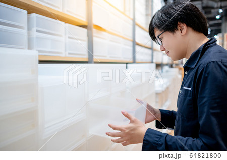 Asian man choosing plastic box drawer in furniture Asian man choosing plastic box drawer in furniture 64821800
