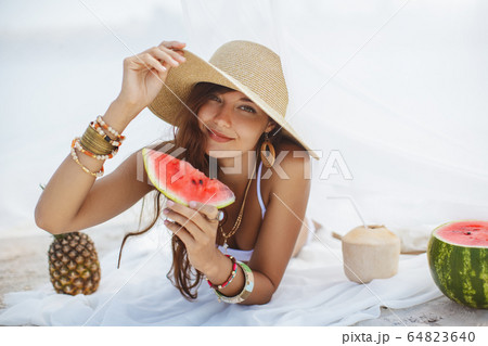 Woman on the Tropical Beach Eating Watermelon 64823640