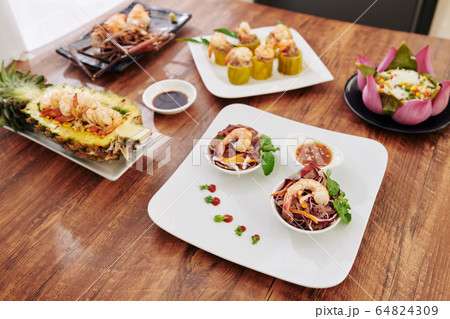 Asian dishes served for dinner 64824309