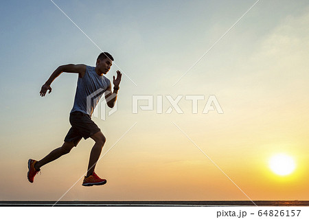 The silhouette of young men running and exercising 64826157