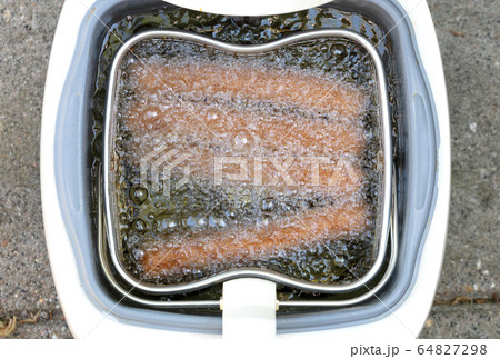 Frikadellen, a Dutch fast food snack in the oil 64827298