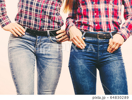 Two women in jeans pants. Two women in jeans pants. 64830289