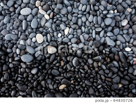 Gray pebbles as a background in the Iceland sea shore. Abstract composition. Gray pebbles as a background in the Iceland sea shore. Abstract composition. 64830726