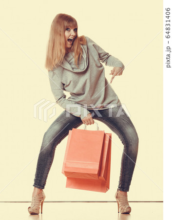 girl in full length with red shopping bags girl in full length with red shopping bags 64831406