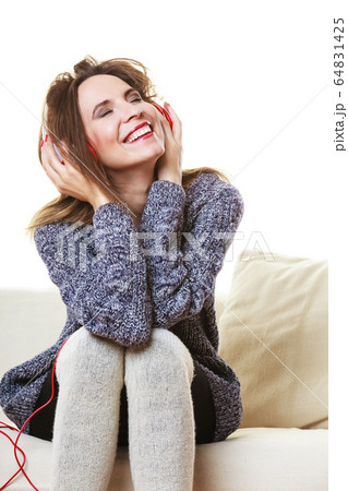 Woman with headphones listening music Woman with headphones listening music 64831425
