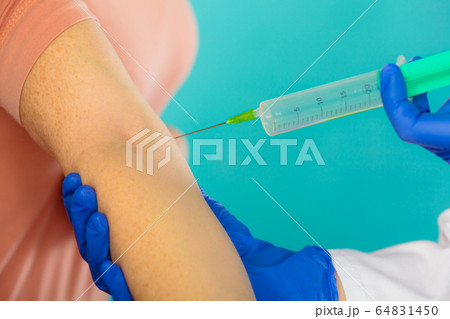 doctor with syringe giving injection to patient. doctor with syringe giving injection to patient. 64831450
