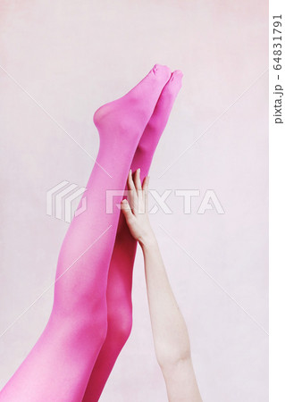 Female legs wearing pink tights 64831791