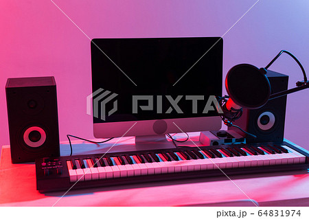 Microphone, computer and musical equipment guitars and piano background. Home recording studio concept. Microphone, computer and musical equipment guitars and piano background. Home recording studio concept. 64831974