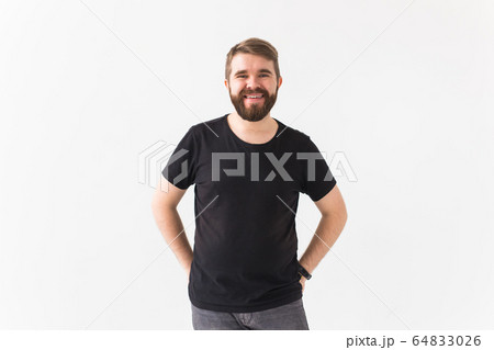 Cheerful guy smiled happily, has excited expression over white studio background. Holidays, youth, emotions concept. 64833026