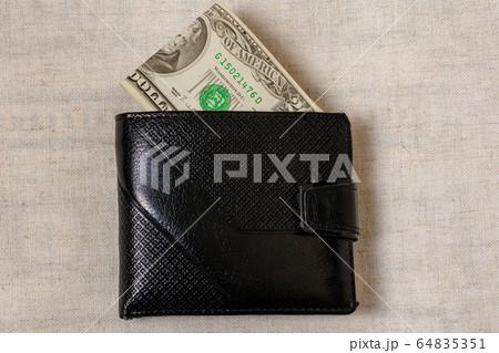 20 dollars sticking out of a wallet of dark 64835351