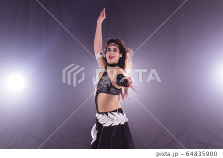 Belly dancer. Young attractive woman dancing...の写真素材 [64835900] - PIXTA