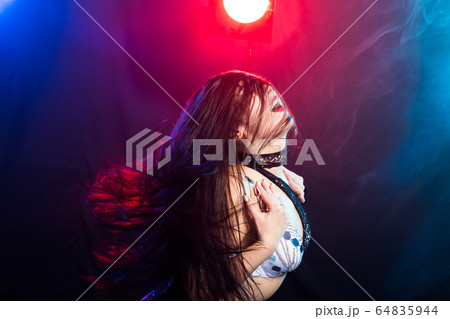 Young woman dancing in Tribal Fusion style. Belly dance on the stage. Young woman dancing in Tribal Fusion style. Belly dance on the stage. 64835944