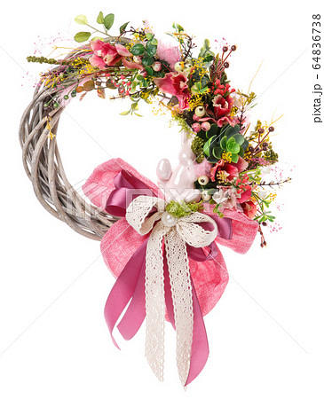 Decoration of the interior, handmade wreath with flowers. The symbol of happiness and prosperity. Decoration of the interior, handmade wreath with flowers. The symbol of happiness and prosperity. 64836738