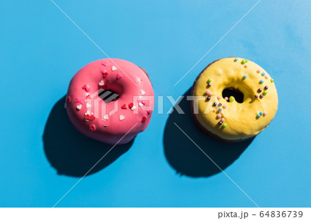 Trendy sunlight. Summer doughnuts on bright light blue turquoise background. Minimal summer concept. Pop art style. Donut Trendy sunlight. Summer doughnuts on bright light blue turquoise background. Minimal summer concept. Pop art style. Donut 64836739