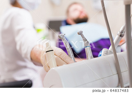 Dental tool equipment in stomatology clinic. Dentistry and dental health concept. 64837483