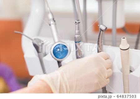 Dental tool equipment in stomatology clinic. Dentistry and dental health concept. 64837503