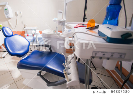 Dentist tools and professional dentistry chair waiting to be used by orthodontist 64837580