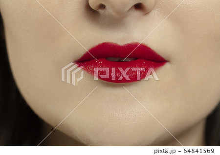 Close-up female mouth with bright red gloss lips make-up. Cosmetology, dentistry and beauty care, emotions 64841569