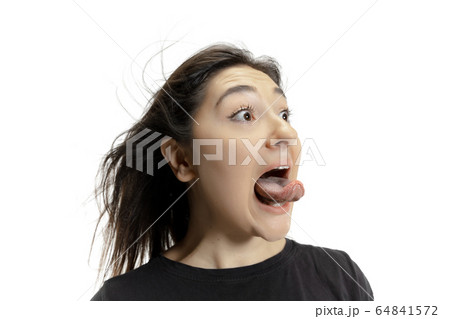 Smiling girl opening her mouth and showing the long big giant tongue isolated on white background, crazy and attracted 64841572