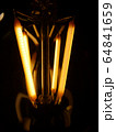 incandescent lamp on a dark background.close-up 64841659