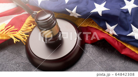 Top view of wooden gavel on background of American flag on black background Top view of wooden gavel on background of American flag on black background 64842308