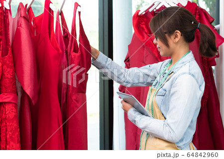 Happy young Asian woman dressmaker fashion 64842960