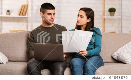Couple having financial problems, managing family budget Couple having financial problems, managing family budget 64843876