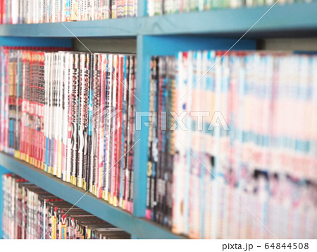 Comic books in bookshelf for background 64844508