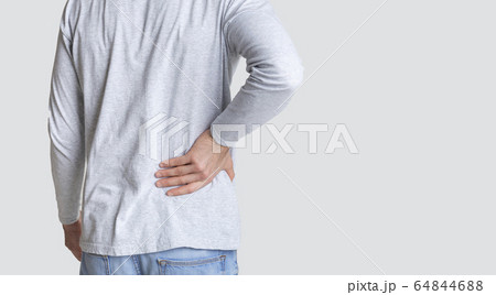 Muscle spasm, rheumatism. Man holds to his back with hand Muscle spasm, rheumatism. Man holds to his back with hand 64844688