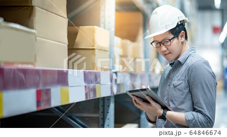 Asian man doing stocktaking by using tablet in 64846674