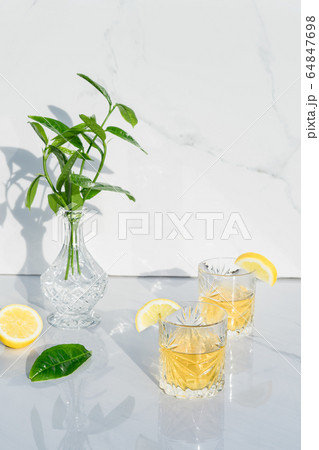Two crystal glasses with yellow cocktails 64847698
