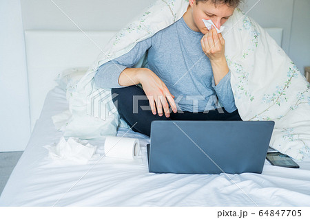 Young caucasian sick man blowing his nose sitting 64847705