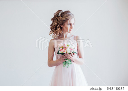 bride in a pink wedding dress and bouquet of flowers bride in a pink wedding dress and bouquet of flowers 64848085