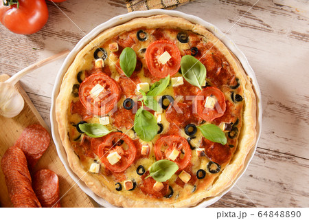 Tart (Quiche) with tomatoes, basil, salami, black 64848890