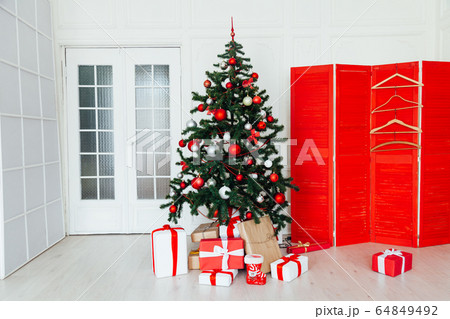 Christmas white room interior with gifts for the new year as a background 64849492