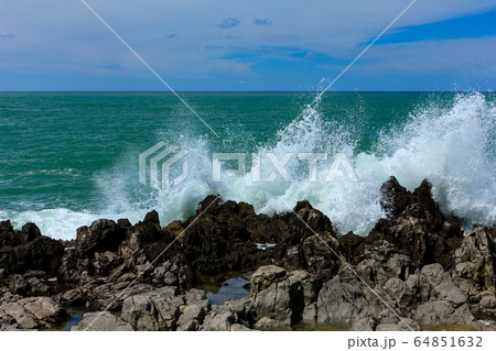 Sea waves crash and splash on rocks. Sea waves crash and splash on rocks. 64851632