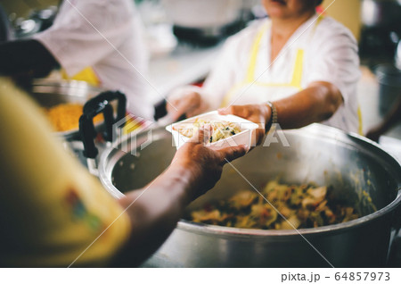 People holding a plate receiving a donation from a 64857973