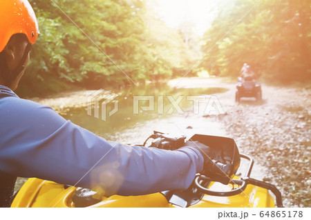 A first-person person driving an off-road ATV, a A first-person person driving an off-road ATV, a 64865178