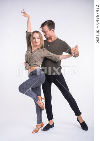 Beauty couple dancing social dance. Kizomba or bachata or semba or taraxia , on white background. Social dance concept. 64867432
